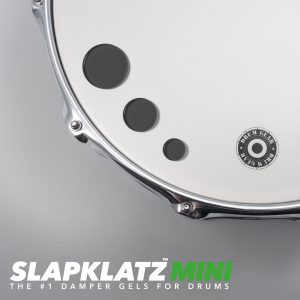 SlapKlatz MINI in black - all 3 sizes shown on a drum head